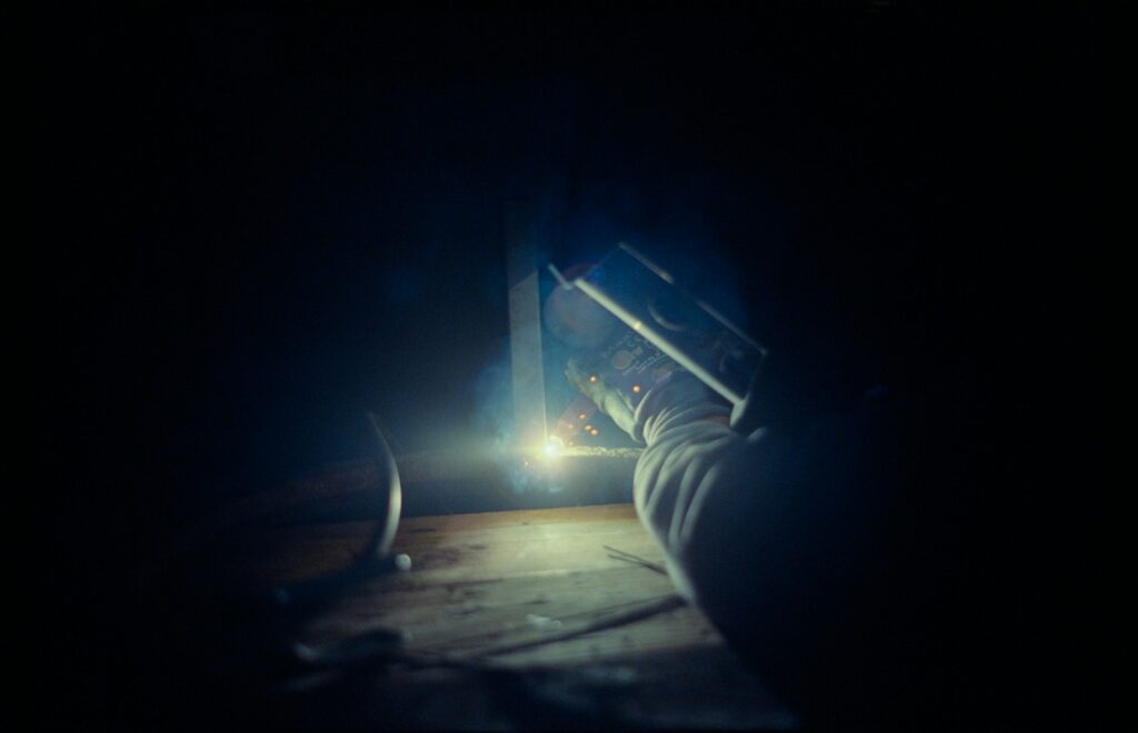 Person holding a flashlight in a dark room